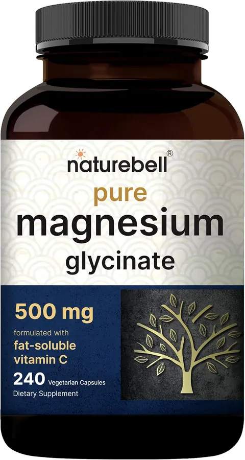 Hand holding two white magnesium glycinate capsules above a glass of water, gym bag visible in background