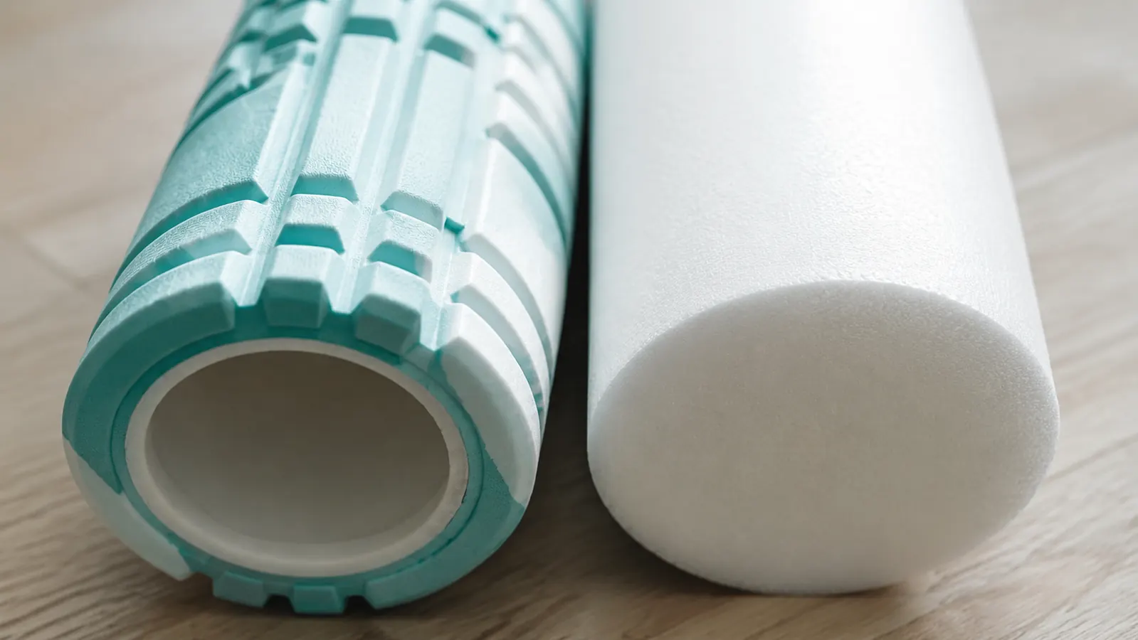 Side-by-side comparison showing TriggerPoint GRID surface texture versus a plain smooth foam roller